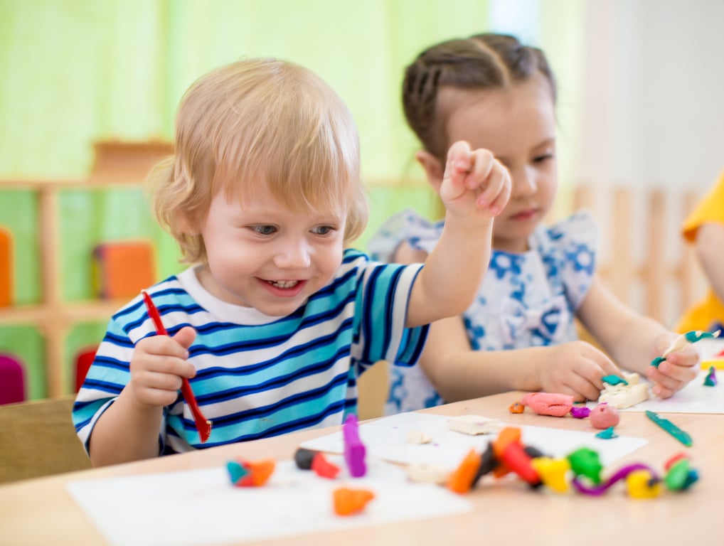 Happy children doing arts and crafts. Kids in kindergarten.