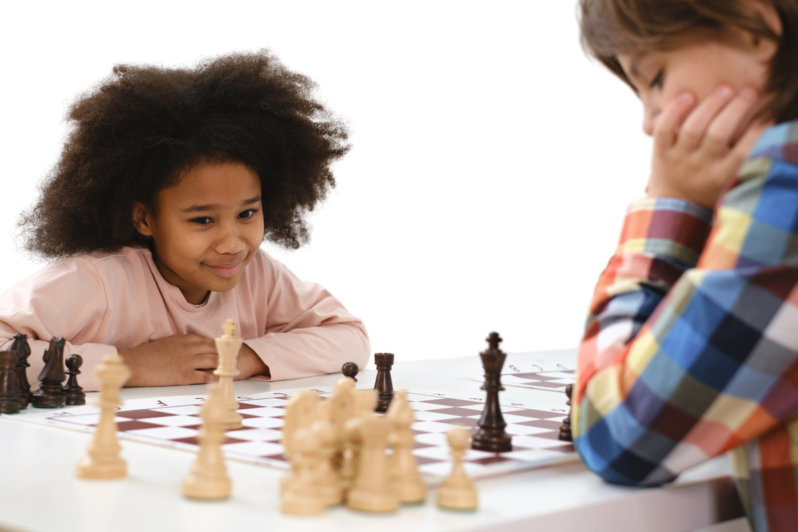 Multiethnic Kids Playing Chess Board Game at School