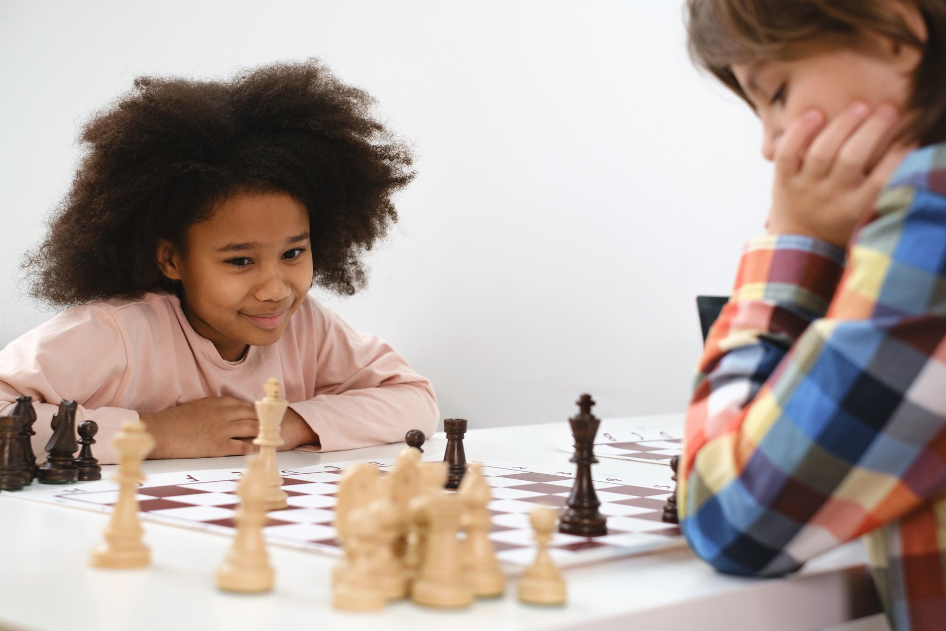 Multiethnic Kids Playing Chess Board Game at School